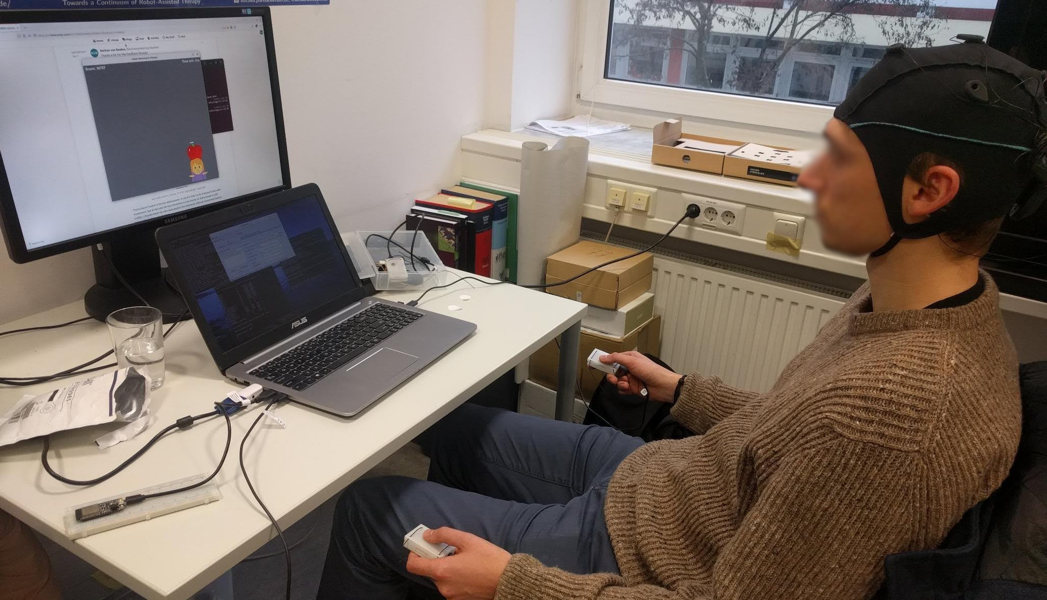 Picture of someone playing the game with EEG and IMUs.